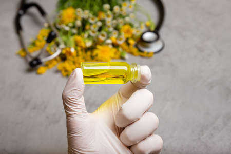 Herbal medicine or aromatherapy dropper bottle. Medical marijuana products. Essential liquid. Essential oil or oil for natural diseases treatment in glass bottle. Natural herbal medicine conceptの写真素材