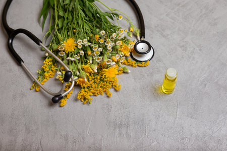 Fresh herbs from the garden and essential oil for aromatherapy on table. Composition of natural alternative medicine with plants. Chinese herbal medicine. Bottle of healthy tincture or infusionの写真素材