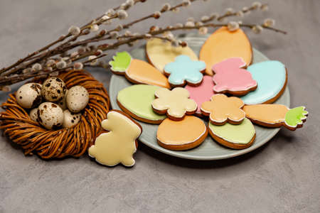 Easter symbols and treats. Multicoloured Ester biscuits in the shape of a bunny, carrots, eggs and...
