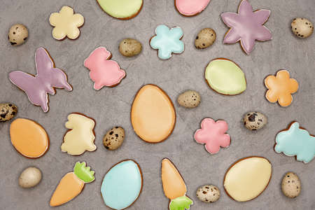 Small Quail eggs on the grey background. Easter spring decorative composition with homemade glazed...