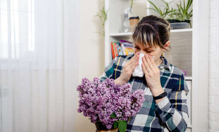 Allergic young woman on spring season. Woman suffering from pollen allergy. Seasonal allergy...
