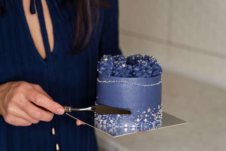 Delicious funny decorated wedding cake. Cheesecake is decorated with flowers. Birthday pie with...