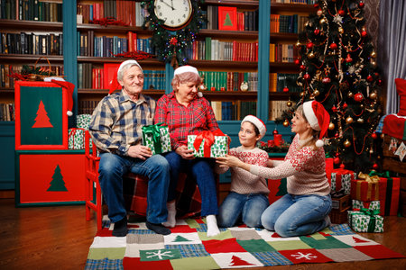 Happy big family holding Christmas presents at home. Family gift exchange tradition on christmas day...