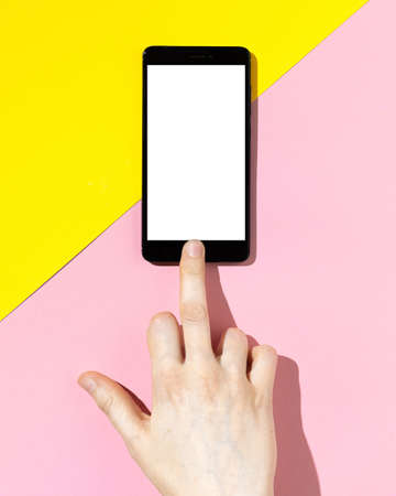 Hand using phone screen and shows gesture of Fuck you. Bad communication concept.の写真素材