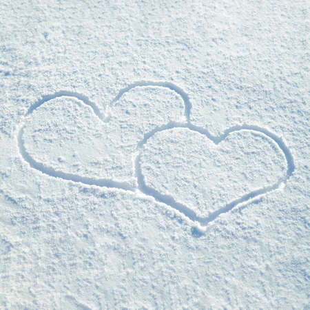 Lovely Hearts Drawn on the Snow in Winter. Top view. Valentines Day concept.の写真素材