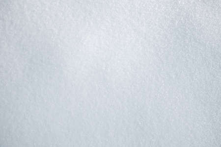 Texture of white snow, the view from the top. Winter solid white background.