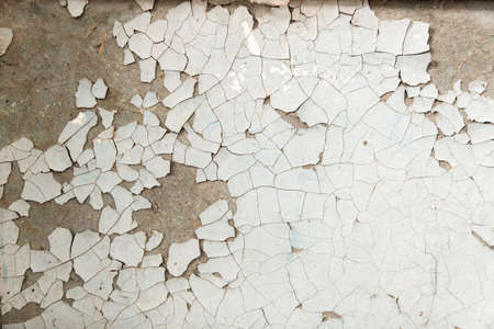Old background with peeling paint cracks and chips. Light white orange texture.