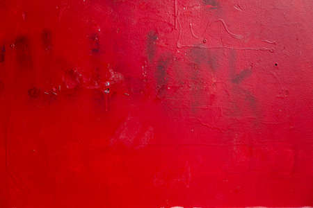 Red metal background. Grungy metal panel. Textured background. Stains on rough faded uneven concrete wall. Old bright red paint.の写真素材