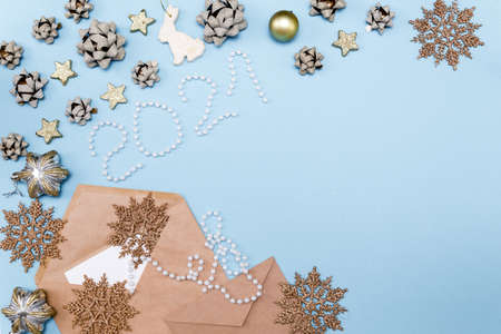 Christmas letter on a sky blue background with Christmas toys. New year's background with gold ornaments bows, snowflakes and stars. Letter to Santa Claus.の写真素材