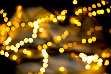 Christmas garlands with blurred focus in the form of bokeh and Golden misty haze on a dark...