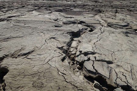 Water-washed land. Cracked crumbling clay and sandy soil after the snow melts in the spring or...