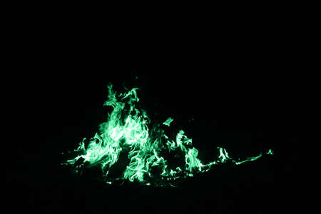 Green flame on a dark background. Green mystical fire abstract flame on a black backgroundの写真素材