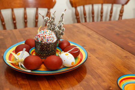 Easter cake with painted eggs on a table made of natural woodの写真素材