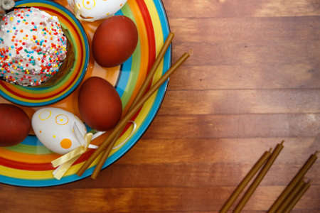 Easter cake with painted eggs on a table made of natural woodの写真素材