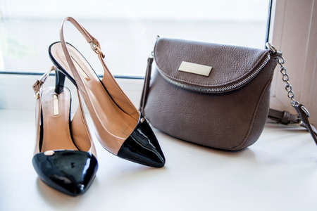 Women's beige bag and shoes. Trendy fashion luxury handbag and heel shoe design. Lifestyle and Beauty Concept. Soft focusの写真素材