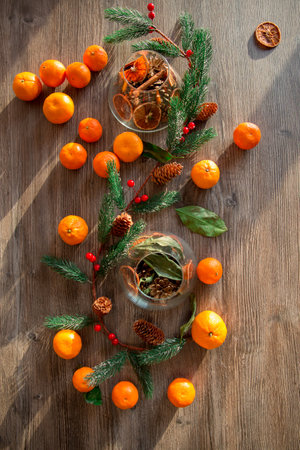 New Year's composition of tangerines and Christmas tree branches on a wooden background. christmas backgroundの写真素材