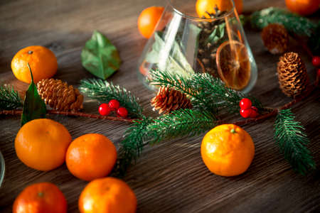 New Year's composition of tangerines and Christmas tree branches on a wooden background. christmas backgroundの写真素材