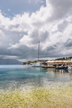 Fiskardo village on the Ionian Island of Kefalonia Greece, summer vacation destination, cloudy sky and beautiful landscape scenery.の写真素材