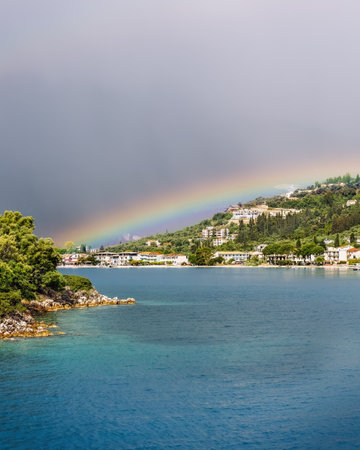 Cruise from Nidri port in Lefkada or Lefkas Greek island, Ionian Sea near Preveza. Summer vacation on boat, cloudy sky and rainbow.の写真素材