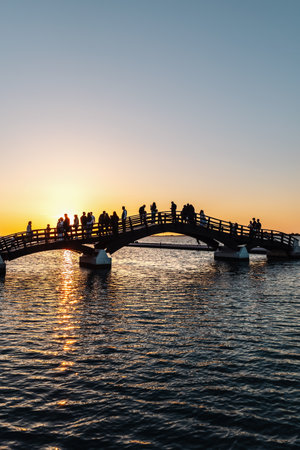 Romantic sunset in Lefkada or Lefkas Greek island, Ionian Sea near Preveza. People silhouette on the bridge, summer vacation.の写真素材