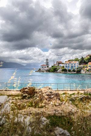 Fiskardo village on the Ionian Island of Kefalonia Greece, summer vacation destination, cloudy sky and beautiful landscape scenery.の写真素材