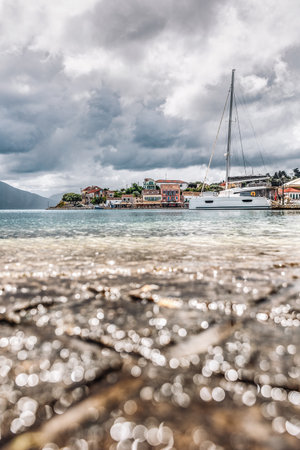 Fiskardo village on the Ionian Island of Kefalonia Greece, summer vacation destination, cloudy sky and beautiful landscape scenery.の写真素材