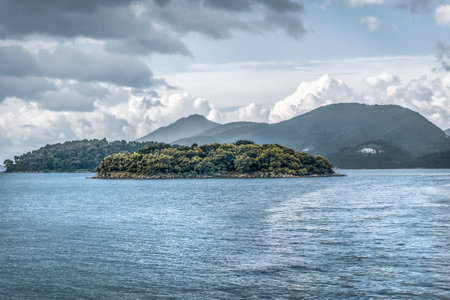 Cruise from Nidri port in Lefkada or Lefkas Greek island, Ionian Sea near Preveza. Summer vacation on boat, cloudy sky.の写真素材