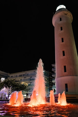 Lighthouse and fountain in Alexandroupolis Evros region Greece, Christmas and New Year decoration, vibrant colors and lights, touristic destination.の写真素材