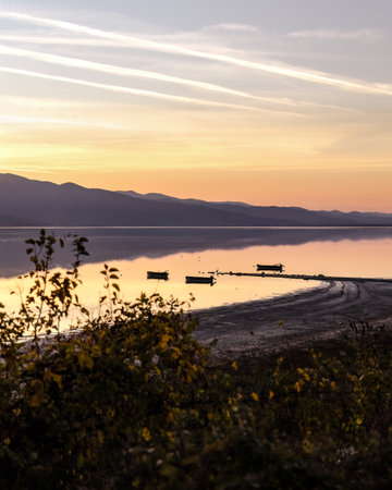 Beautiful sunset scenery on Kerkini lake Macedonia Greece, golden hour and sunrise, boats and water reflection, autumn leaves.の写真素材
