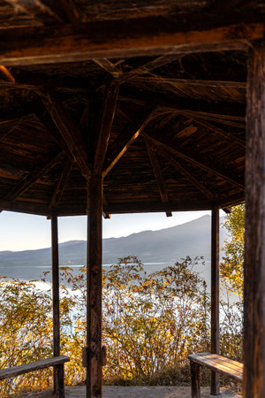 Beautiful autumn scenery on Kerkini lake Macedonia Greece, fisherman and a boat, dalmatian pelicans waiting for fish.の写真素材