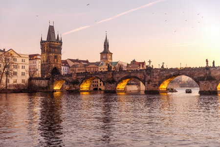 Sunset colors in Prague Historical Gothic Medieval castle, St. Vitus Cathedral, Charles Bridge and river Vltava boat cruise, astronomical clock, Unesco city tourism, golden hour and water reflection.の写真素材