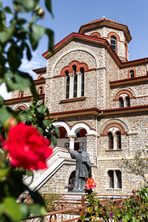 05-10-2025, Metropolitan Church of Agios Panteleimon in Florina Greece, river canal and trees around, flowers in the foreground, historic buildings and neighborhood, Arcturos brown bear shelter.のeditorial素材