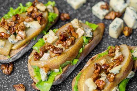 Snack bruschetta with pear, honey, walnut, cheese, green salad and olive oil