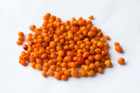 Close up frozen sea buckthorn berries on a white background isolated Healthy food vitamins snack...