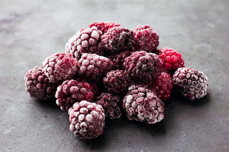 Close up of frozen blackberries on a dark background Healthy food vitamins snack dessertの写真素材