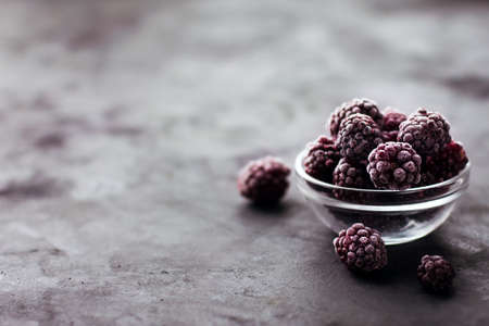 Close up of frozen blackberries on a dark background Healthy food vitamins snack dessertの写真素材