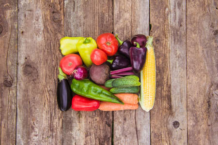 Fresh crop of vegetables on a wooden background, copy space, farmer's harvest, vegetable garden and...