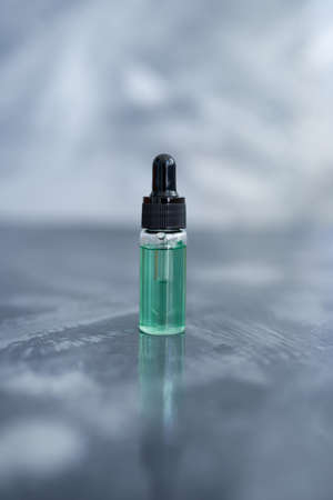 Essential oil bottle on the grey tableの写真素材
