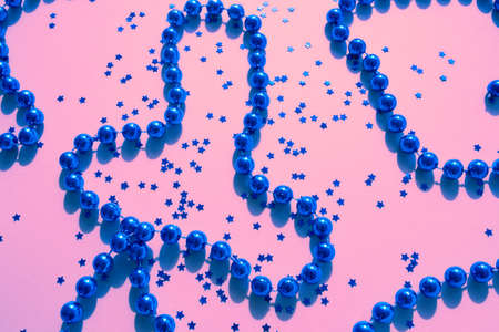 Blue sparkles and stars on pink pastel trendy background.の写真素材