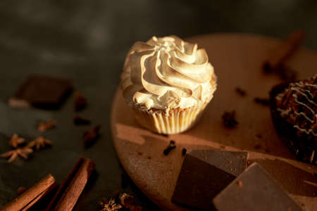 Tasty desserts, cake and cinnamon on the dark backgroundの写真素材