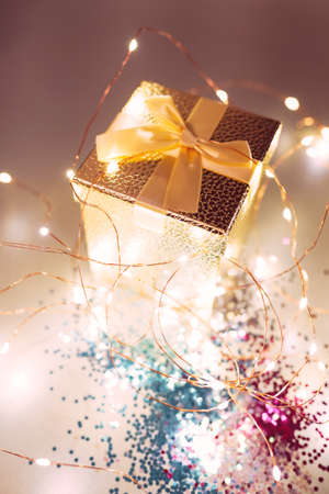 Christmas gift box wih festive lights and glitterの写真素材
