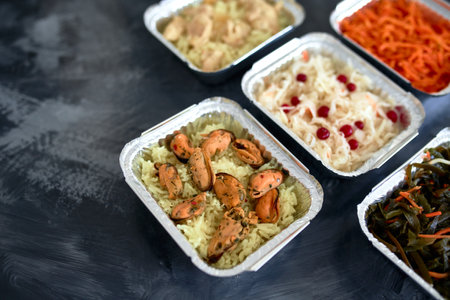 Different foil containers with delicious food. Delivery serviceの写真素材