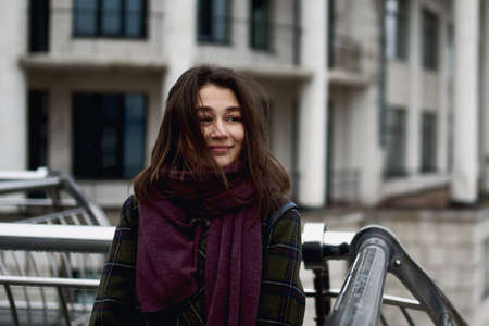 Portrait of beautiful young woman standing in the city