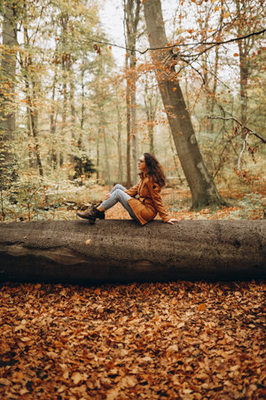 Woman walking in the autumn forestの写真素材