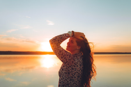 Portrait happy laughing woman in pink dress playful having fun on desert beach of salt pink lake. Ukrainian salt lakeの写真素材