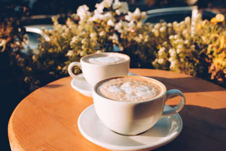 Cup of cappuccino on the wooden table. Beautiful foam and ceramic cupの写真素材