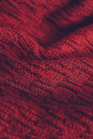 Beautiful knitted texture of red sweater. close up background.