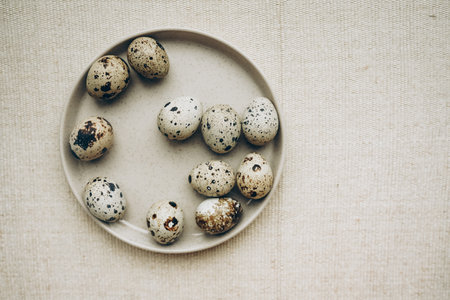 Easter eggs on beige background. Quail eggs natural easter decoration.の写真素材