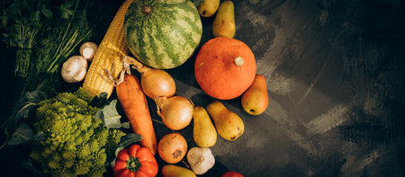 Organic harvest fruits and vegetables from garden. Vegetarian ingredients for cooking on dark rustic background, top viewの写真素材