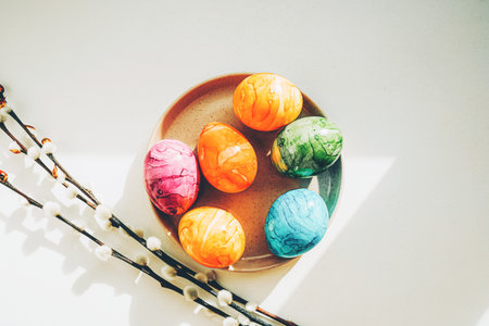 Blooming branches of the pussy willow and colored Easter eggs.の写真素材
